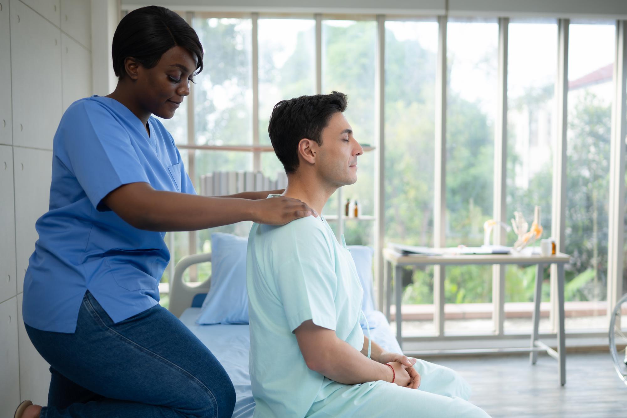 Physical therapist providing leg massage during recovery treatment